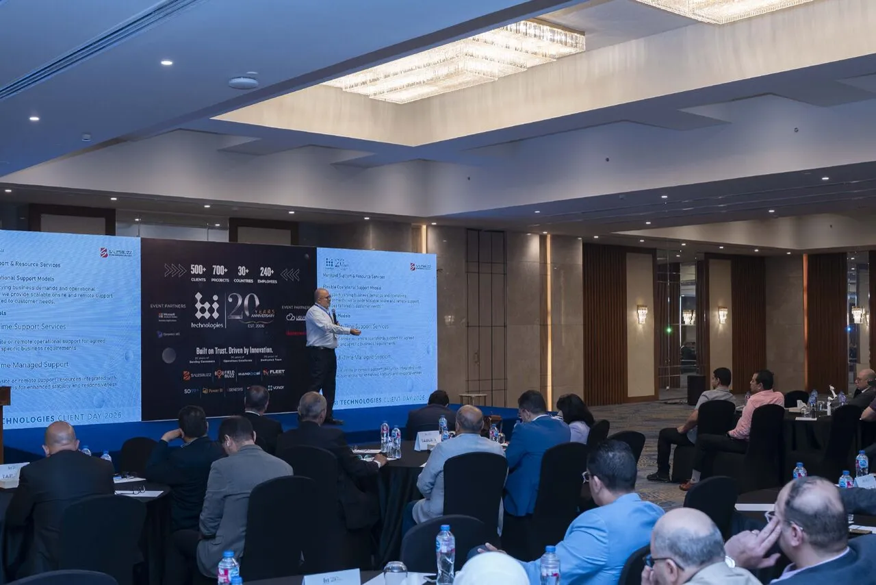 Wide view of the Client Day 2026 ballroom, with customers and partners seated at tables as Peter presents on stage