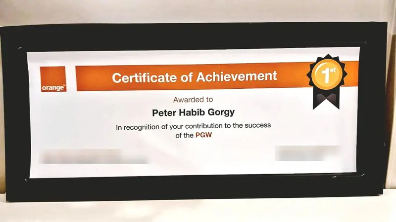 Orange Certificate of Achievement awarded to Peter Habib Gorgy “in recognition of your contribution to the success of the PGW” (signatories’ names blurred).